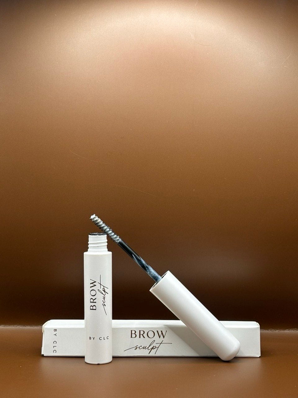 Brow Sculpt open tube with gel on the spoolie and the box
